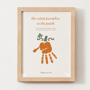 May include: A framed print featuring an orange handprint shaped like a pumpkin with a green stem and leaves. The text reads: the cutest pumpkin in the patch, My tiny hand made a pumpkin so sweet, The cutest little pumpkin you'll ever meet! Halloween 2026.