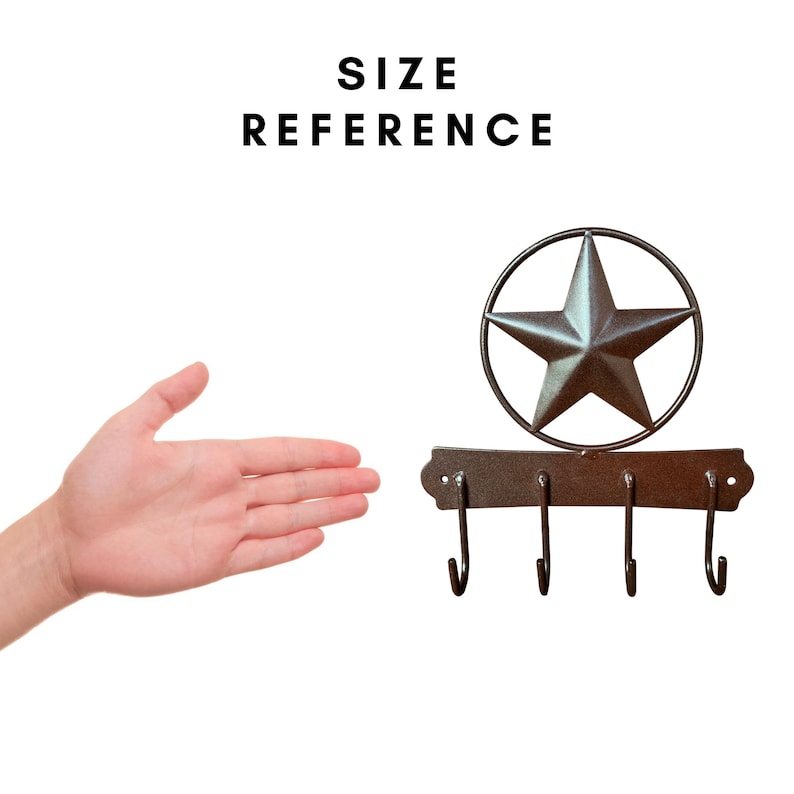 May include: A metal key holder with four hooks and a large, silver star in a circle. The star is centered above the hooks. The key holder is brown and has a rustic finish. "SIZE REFERENCE" is written in black text above the key holder.