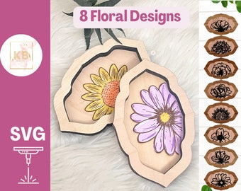 May include: Eight floral designs for laser cutting. The designs include a sunflower, daisy, and other floral patterns. The designs are shown on a wooden background. The text "8 Floral Designs" is at the top of the image. The text "SVG" is at the bottom left of the image. The text "Digital Files for Laser Cutters" is at the bottom of the image.