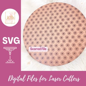 May include: A round cork coaster with a floral pattern. The coaster is scored for easy bending. The text "Scored File" is printed on the coaster.