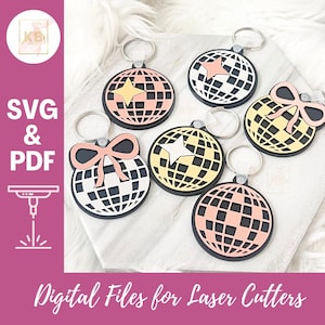 May include: Six different laser cut keychains featuring a disco ball design. Each keychain has a different color and design element, including a star, a bow, and a checkered pattern. The keychains are made of acrylic and are perfect for adding a touch of fun to your keys.