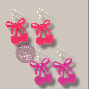 May include: A pair of pink cherry earrings with a bow on top. The earrings are made of acrylic and have a gold hook.