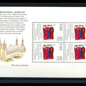 May include: A postage stamp sheet featuring a commemorative stamp for the Franconian Apostles. The stamp depicts three figures in red, blue, and purple robes, with text in Gaelic and the number 28. A watercolor illustration of Würzburg Cathedral is also present.