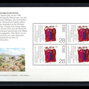 May include: A sheet of postage stamps from Ireland, featuring illustrations of three figures in red and blue robes. The stamps are labeled "ÉIRE" and "28". The sheet also includes text in German and English about Irish saints.
