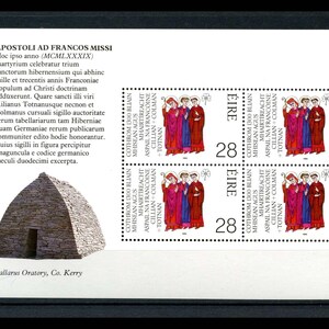 May include: A postage stamp sheet featuring four stamps with a depiction of three figures in red, purple, and blue robes. The stamps have the word "EIRE" and the number "28". The sheet also includes text in Latin and Irish, and an illustration of a stone building.
