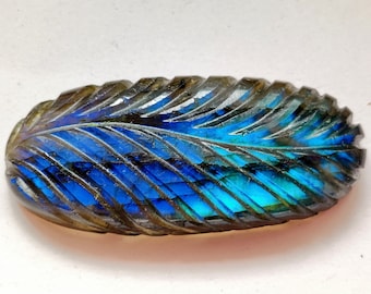 May include: A blue and gray labradorite gemstone carved into a feather shape.