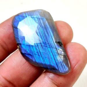 May include: A blue and gray labradorite gemstone with iridescent flashes of color.