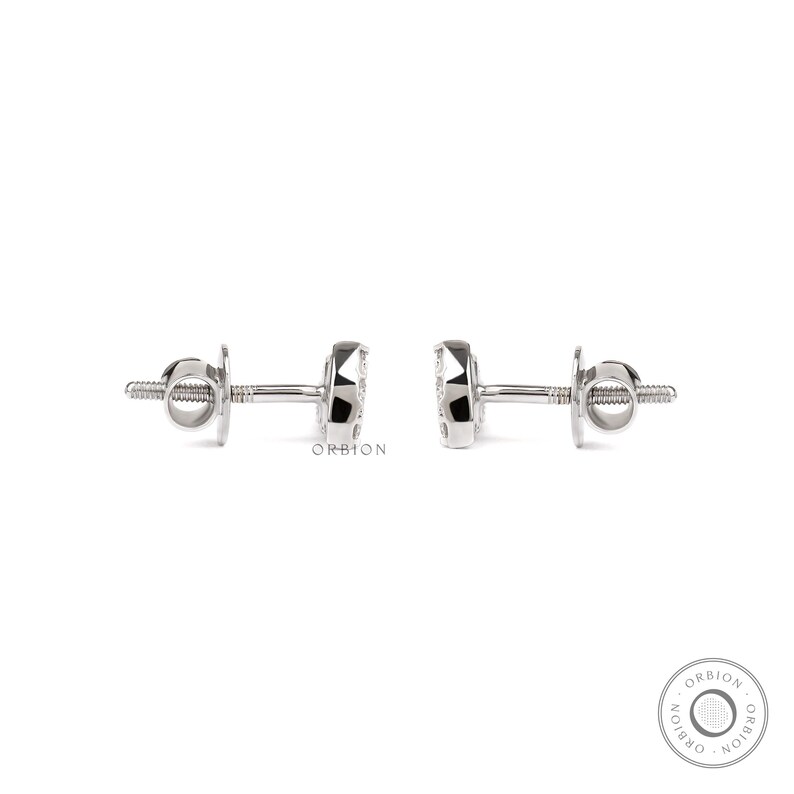 May include: A pair of silver stud earrings with a small round diamond in the centre of each earring.