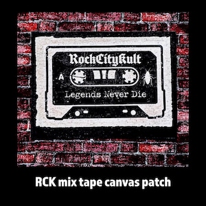May include: Black and white canvas patch featuring a cassette tape design with the text "RockCitykult" and "Legends Never Die." The patch is set against a brick wall background.