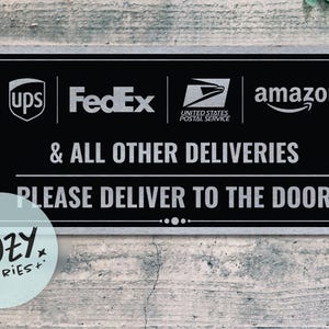 May include: Black rectangular sign with white text and logos for UPS, FedEx, Amazon, and the United States Postal Service. The sign reads "& ALL OTHER DELIVERIES PLEASE DELIVER TO THE DOOR."