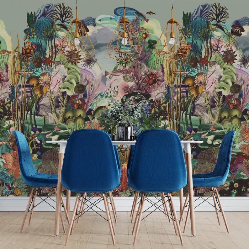 May include: A dining room with a white table and four blue velvet chairs. The chairs have wooden legs and are set against a vibrant mural of an underwater scene. Gold geometric pendant lights hang above the table. The room has a modern, artistic feel.