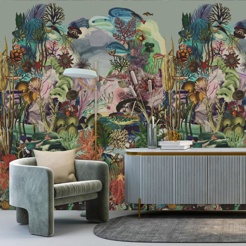 May include: A vibrant mural of an underwater landscape featuring coral, fish, and aquatic plants. A modern grey armchair with a beige cushion is positioned in front of the mural. A light blue cabinet with gold trim and a grey rug complete the room.