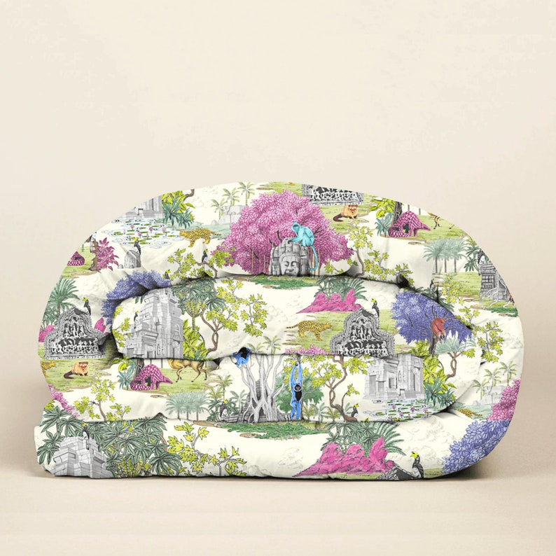 May include: A white duvet cover featuring a colourful jungle scene print. The print includes trees, flowers, animals and a temple.