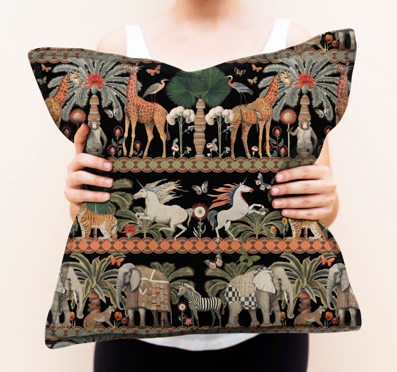 May include: A black throw pillow with a colorful, whimsical pattern featuring animals, plants, and geometric designs. The pattern includes giraffes, unicorns, elephants, tigers, and palm trees.