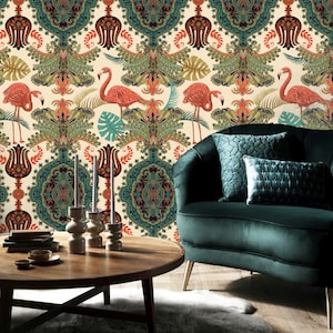May include: A green velvet armchair with a patterned throw pillow sits in front of a wall covered in a cream-colored wallpaper with a repeating pattern of pink flamingos, green leaves, and intricate floral designs.