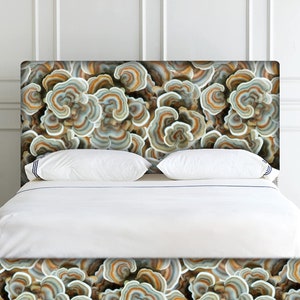 May include: A white bed with a headboard featuring a mushroom-like pattern in shades of brown, gray, and white.