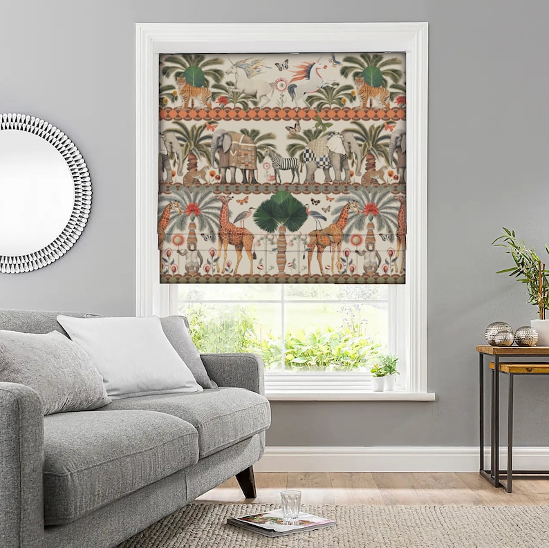 May include: A white roman shade with a colorful pattern of animals, including giraffes, elephants, zebras, and tigers. The pattern is repeated in a horizontal band across the shade.