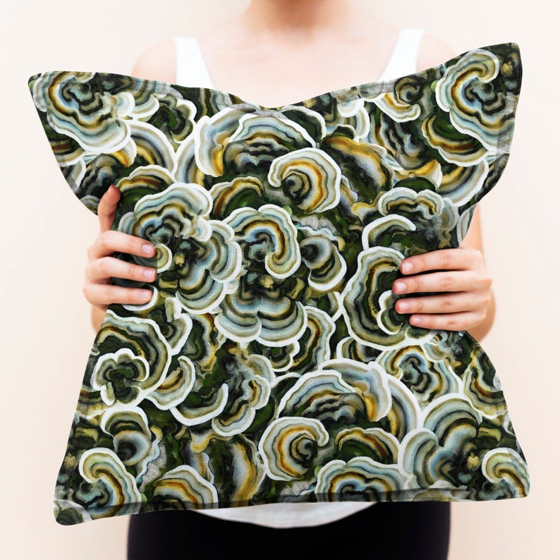 May include: A decorative throw pillow with a green, white, and yellow mushroom pattern. The pillow is made of a soft, comfortable fabric and features a unique, nature-inspired design.