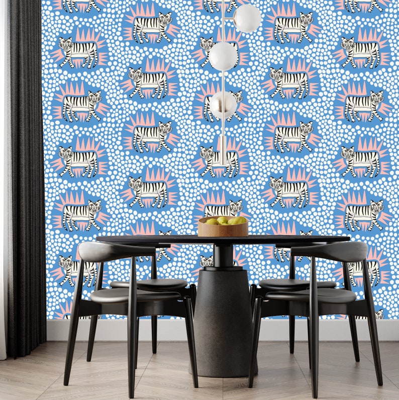 May include: A dining room with a blue and white wallpaper featuring a repeating pattern of white tigers with pink accents. The wallpaper has a polka dot pattern. A black table with four black chairs is in the center of the room.