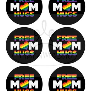 May include: Six round black and white stickers with the text "FREE MOM HUGS" in white with a rainbow heart in the middle of the word "MOM".