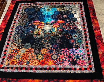 King size Gnome Mushroom Forest handmade quilt that measures 100 inches wide x 108 inches long.  It’s mostly black, red and earth tones.