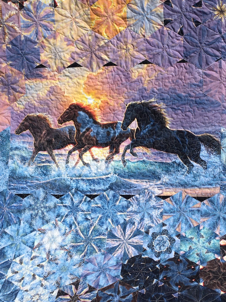 Queen size ‘Sunset Horses’ One Block Wonder that measures 91 inches wide x 92 inches long, has a variety of colors, with blues and browns.
