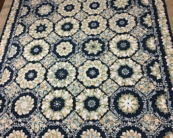 King size kaleidoscope handmade quilt that measures 93 x 103 in creams, off white and navy blue. Strips cut to make triangles then octagons.