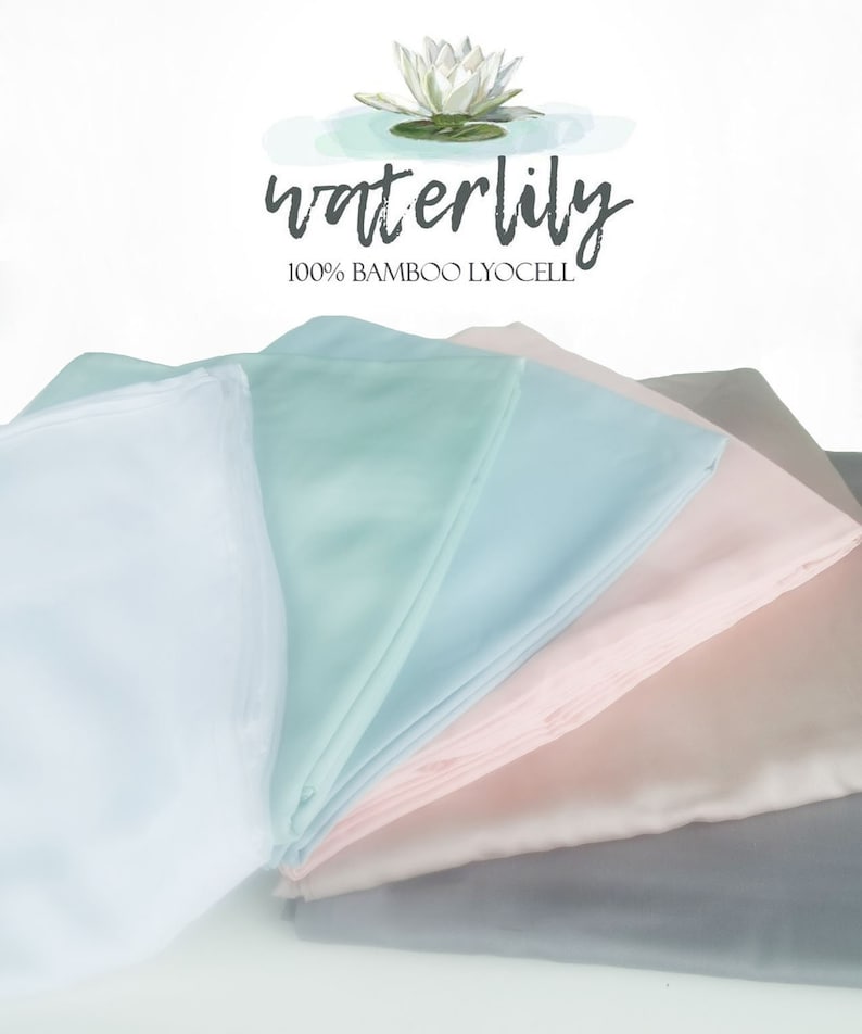 May include: A stack of five fabric squares in different pastel colors, including light blue, pale pink, and gray. The fabric is smooth and silky. The text "waterlily 100% BAMBOO LYOCEL" is visible at the top of the image.