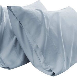 May include: Two light blue pillowcases made of soft, smooth fabric. The pillowcases are wrinkle-resistant and easy to care for.
