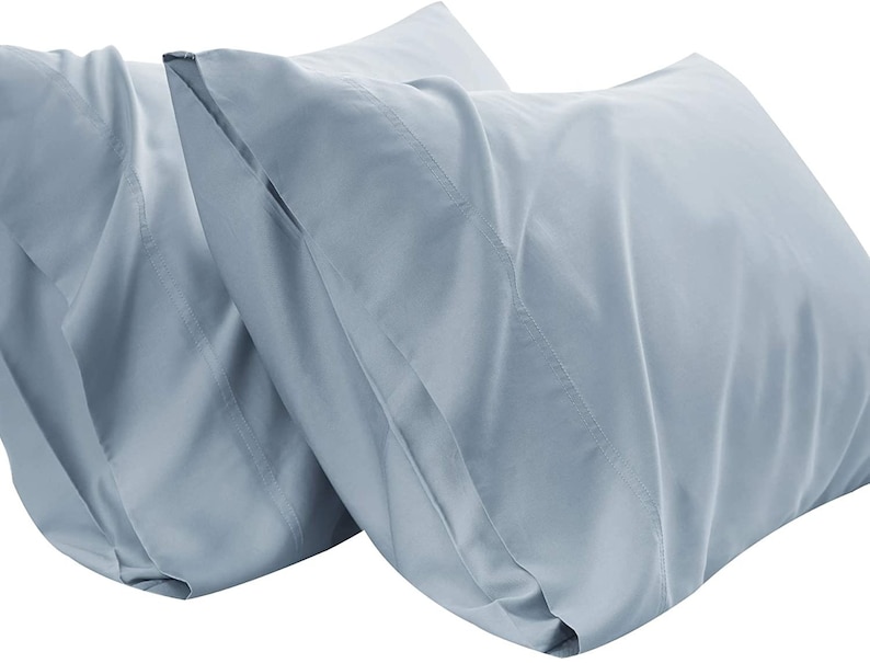 May include: Two light blue pillowcases made of soft, smooth fabric. The pillowcases are wrinkle-resistant and easy to care for.