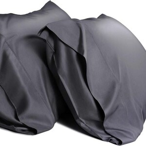 May include: Two gray pillowcases made of a soft, smooth fabric. The pillowcases are folded and stacked on top of each other.
