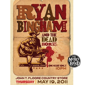 May include: A vintage-style concert poster advertising a performance by Ryan Bingham and the Dead Horses. The poster features a drawing of Ryan Bingham playing a guitar, with the text "Ryan Bingham and the Dead Horses" in large, bold letters. The poster also includes the date and location of the concert: "Thursday, May 19, 2011, John T. Floore Country Store, Helotes, Texas".
