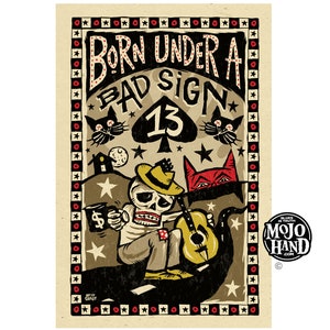May include: A vintage-style poster with a skeleton playing a guitar. The poster is titled "Born Under A Bad Sign" and features a black spade with the number 13. The poster is surrounded by a black and white checkered border.