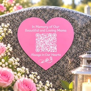 May include: A heart-shaped pink memorial plaque featuring the white text In Memory of Our Beautiful and Loving Mama, a central QR code, and the phrase Always in Our Hearts, finished with a small infinity symbol, rose, and butterfly graphic.