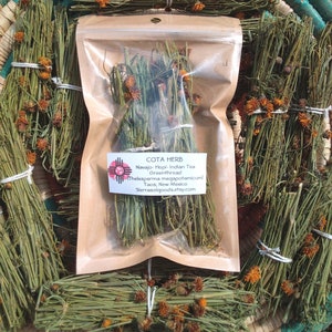 May include: A clear plastic pouch containing dried Cota herb, labeled with the text Cota Herb, Navajo-Hopi-Indian Tea, Greenthread, Thelesperma megapotamicum, Taos, New Mexico, and sierrasolgoods.etsy.com, surrounded by bundles of the same herb.