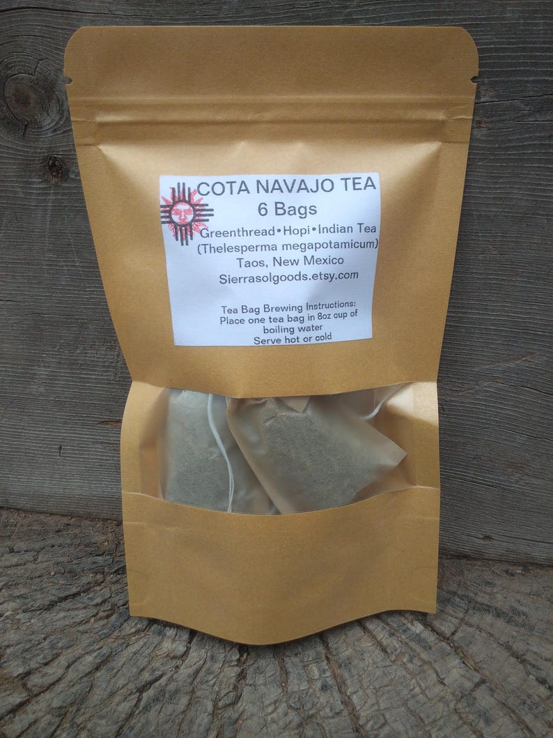 May include: A brown paper pouch containing 6 bags of Cota Navajo Tea. The label reads: COTA NAVAJO TEA, 6 Bags, Greenthread, Hopi, Indian Tea, Thelesperma megapotamicum, Taos, New Mexico, Sierrasolgoods.etsy.com, Tea Bag Brewing Instructions: Place one tea bag in 8oz cup of boiling water, Serve hot or cold.