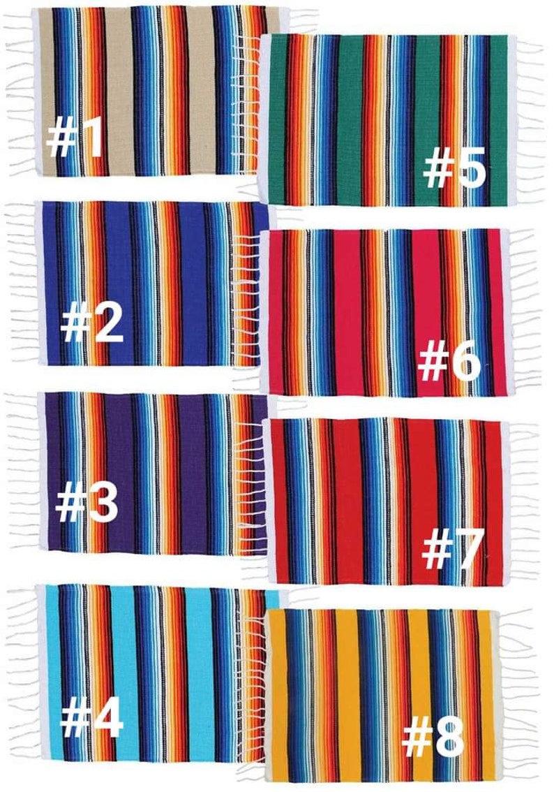 May include: A collection of eight colorful serape blankets, each with a unique striped pattern. The blankets feature vertical stripes in various colors, including blue, red, orange, and green, with white fringe on the edges. Each blanket is labeled with a number.