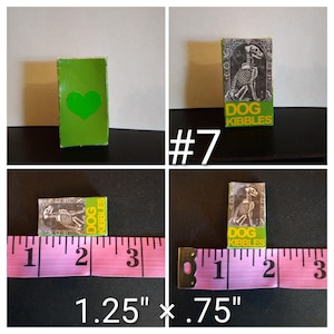 May include: A miniature green box with a heart cutout and a small box labeled "DOG KIBBLES" with a dog skeleton illustration. The boxes measure 1.25" x .75".