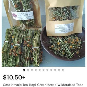 May include: Bundles of dried green Cota herb with small orange flowers, packaged in clear and tan pouches with labels reading Cota Herb Navajo-Hopi Indian Tea, alongside loose dried herbs in a dark brown bowl, totaling 0.5 ounces of tea.