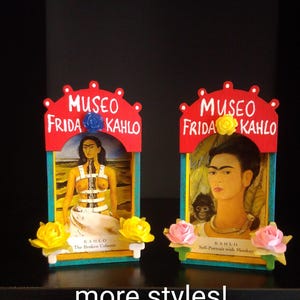 May include: Two decorative Frida Kahlo art pieces. Each features a painting of Frida Kahlo, with the words "MUSEO FRIDA KAHLO" above. One piece is "The Broken Column" and the other is "Self-Portrait with Monkey". The phrase "more styles!" is at the bottom.
