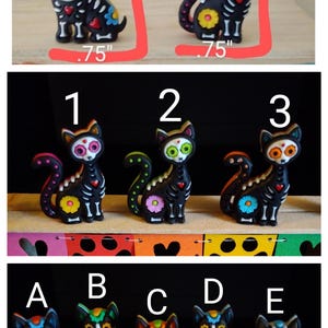 May include: A collection of Day of the Dead-themed figurines. The image shows several black cat and dog figurines with colorful floral and skeletal designs. The figurines are approximately 1 inch to 1.25 inches tall.