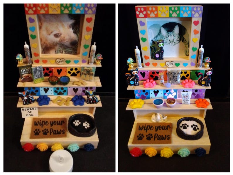 May include: A wooden pet display shelf with a framed photo of a dog and cat. The shelves are decorated with paw prints, hearts, and miniature pet supplies. The bottom shelf has a sign that reads "wipe your paws".