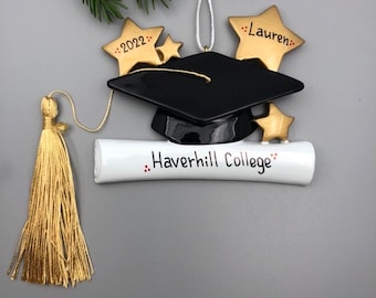 May include: A black graduation cap with a gold tassel and a white diploma scroll with the text "Haverhill College" and "2022" on gold stars.