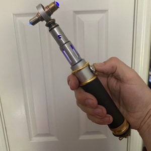 Modernized Classic Sonic Screwdriver with blue lights, sound, and leather handle.