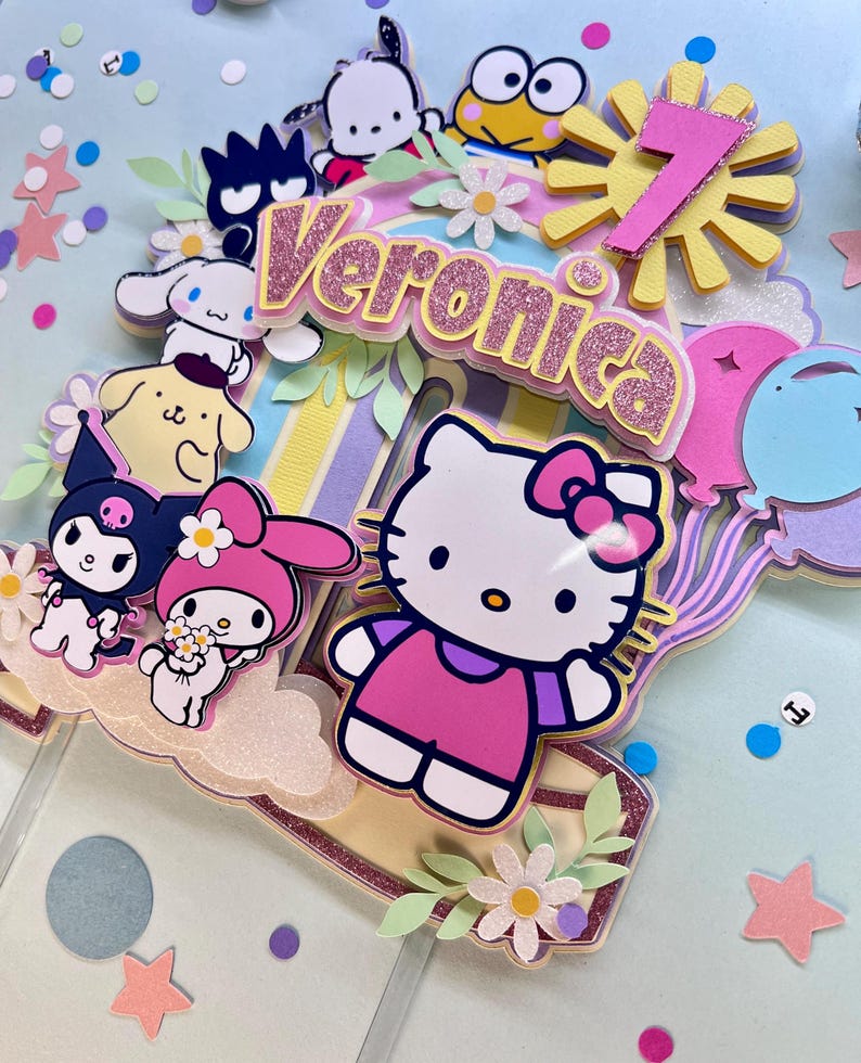 May include: A colorful cake topper featuring Hello Kitty, My Melody, and other cartoon characters. The topper includes a pink and yellow sun with the number 7, a pink and white banner with the name Veronica, and a variety of flowers and leaves.