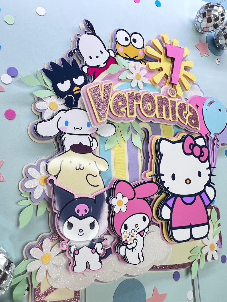 May include: A colorful cake topper featuring Hello Kitty, My Melody, Kuromi, and other popular Japanese cartoon characters. The topper is decorated with flowers and a rainbow-colored background. The name "Veronica" is spelled out in pink glitter letters.