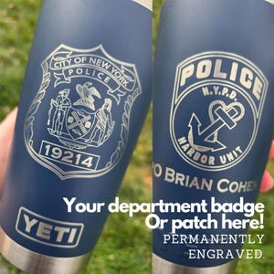 May include: A blue Yeti tumbler with a silver engraved design. The design features the City of New York Police Department logo and the text "19214". The tumbler also has the text "Your department badge or patch here! Permanently engraved."