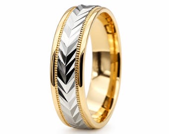 May include: A two-tone ring featuring a polished yellow gold band with a central silver-colored inlay. The silver section displays a repeating chevron pattern, bordered on both sides by a delicate beaded texture that runs along the edges.