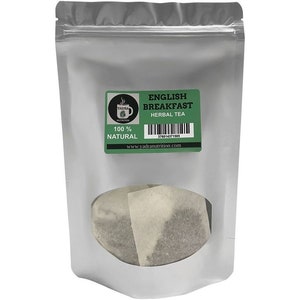 May include: A silver resealable pouch containing English Breakfast Herbal Tea. The pouch has a clear window showing several tea bags. The label on the pouch reads "English Breakfast Herbal Tea" and "100% Natural".