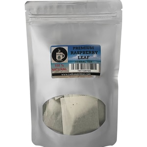 May include: A silver pouch with a clear window showing several tea bags. The pouch has a label that reads "PREMIUM RASPBERRY LEAF HERBAL TEA 100% NATURAL" and a website address: www.yadranutrition.com.